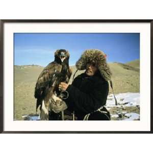 Kazakh Eagle Hunter Poses with His Eagle on a Plain in Kazakhstan 