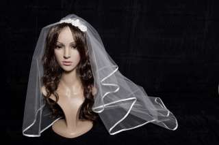 The veil edge is surrounded by white ribbon. It is mounted on a 