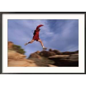  A Runner Leaps Across Rocks in Moab, Utah National 