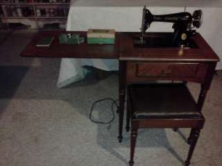 This is a 1946 Singer Electric Sewing Machine with stand, chair, and 