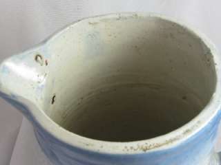 Offered is an antique blue and white turned stoneware pitcher that 