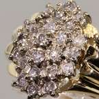   from 14k yellow gold a mound of round brilliant diamonds are clustered