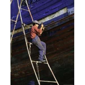 Man on Ladder Repairing Boat, Morocco Premium Poster Print by Michael 