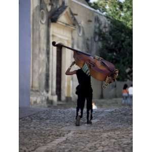 Musician Carrying Double Bass Along Cobbled Street to Plaza Mayor 