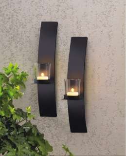 This pair of black metal and glass wall mount tea light holders make a 
